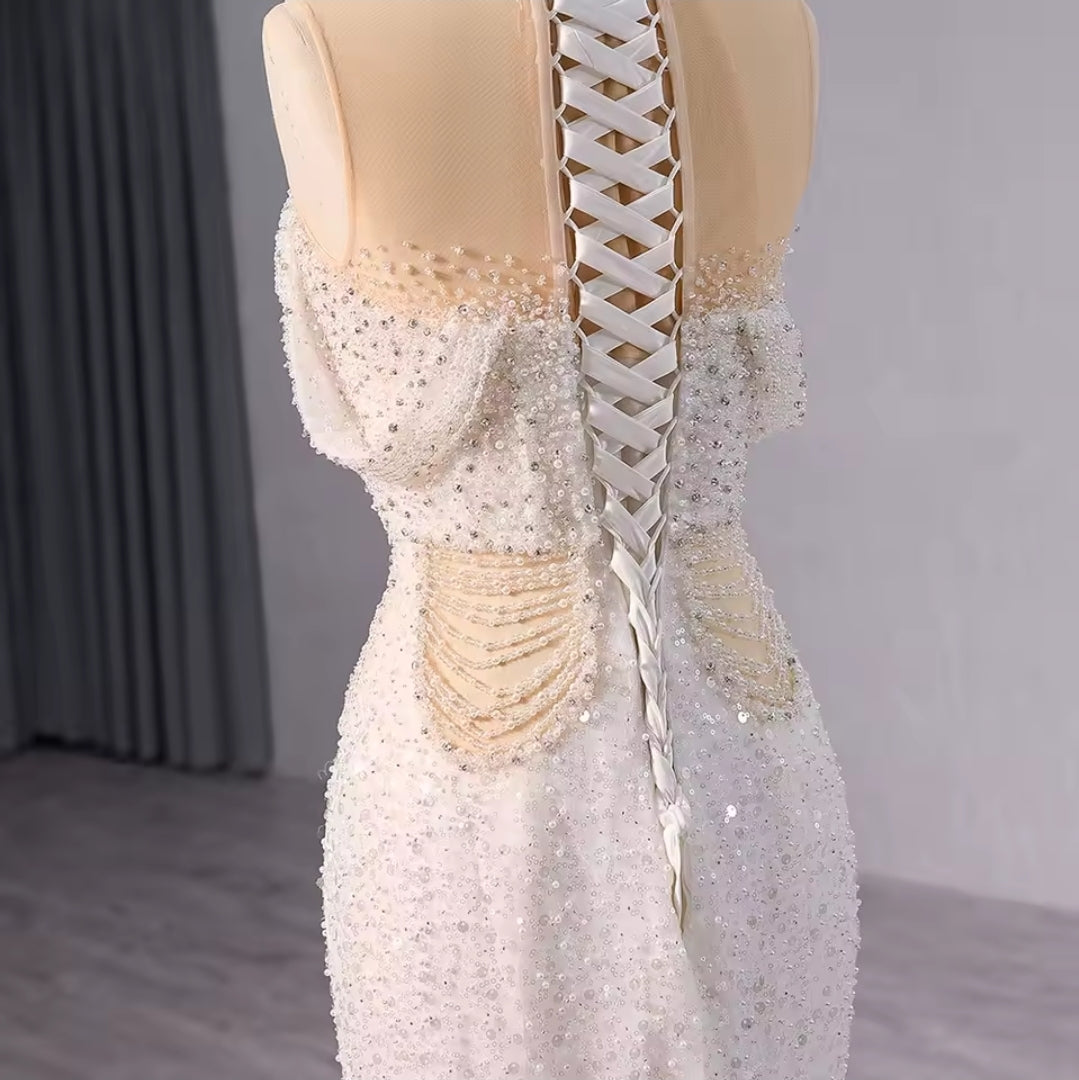 Elegant Sleeveless Crystal Beaded Illusion Boat Neck Bridal & Ceremonial Gown With Draped Beading And Cutout Center Detail