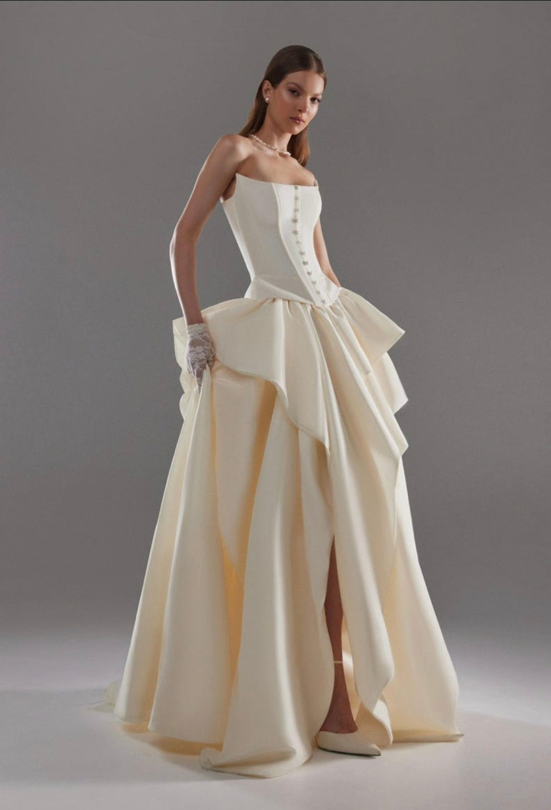 Cat Eye Boat Neck Strapless Front Multi Button Detail Corset Bridal And Ceremonial Gown With Multi Layered Skirt And Split Hem