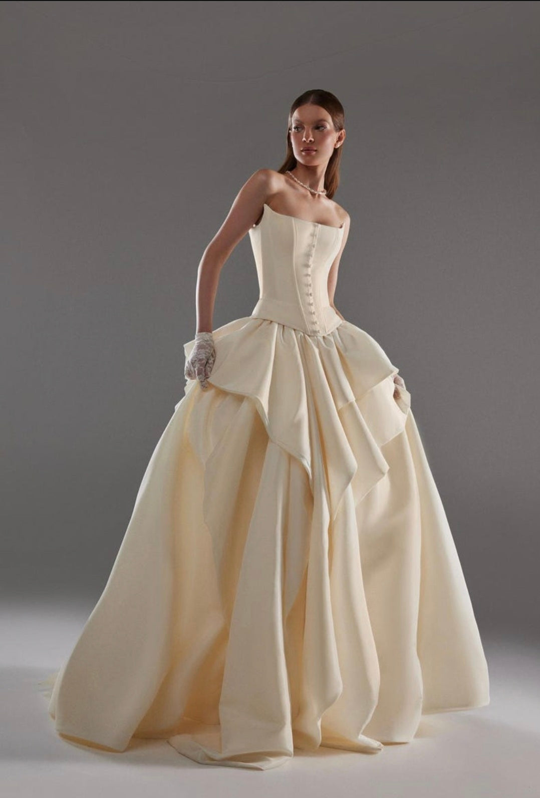 Cat Eye Boat Neck Strapless Front Multi Button Detail Corset Bridal And Ceremonial Gown With Multi Layered Skirt And Split Hem