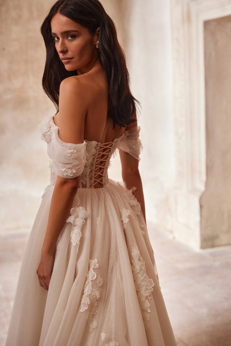 Shimmering 3D Floral Vine Corset Bow Accent Off The Shoulder A-Line Bridal Gown With Scattered Back Train Floral Appliqués
