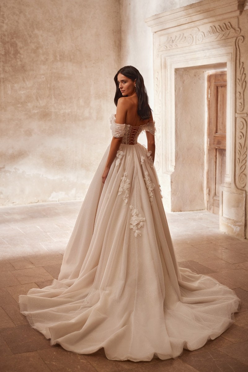 Shimmering 3D Floral Vine Corset Bow Accent Off The Shoulder A-Line Bridal Gown With Scattered Back Train Floral Appliqués