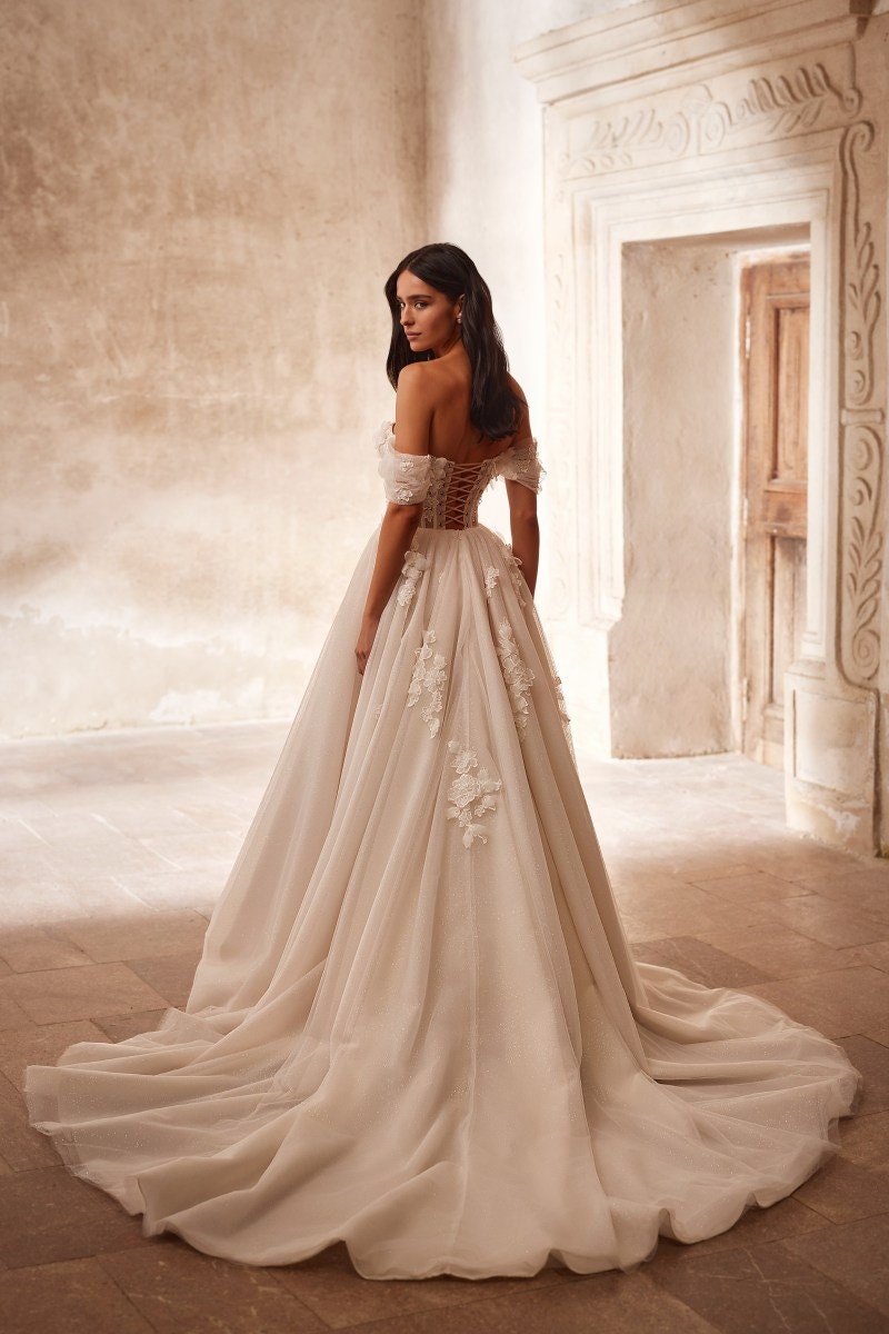 Shimmering 3D Floral Vine Corset Bow Accent Off The Shoulder A-Line Bridal Gown With Scattered Back Train Floral Appliqués