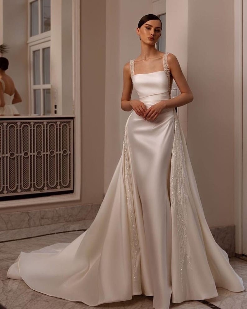 Sleeveless Multi Crystal Beaded Square Neck Satin Minimalist Gown With Detachable Sequin Appliqué Detail Train