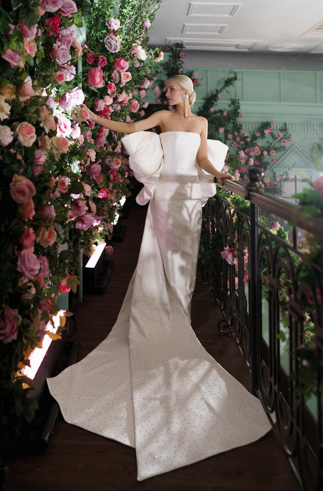 Boat Neck Strapless Scattered Crystal Embellished Satin Sheath Gown With Back Split Hem And Oversized Crystal Embellished Bow Knot Train