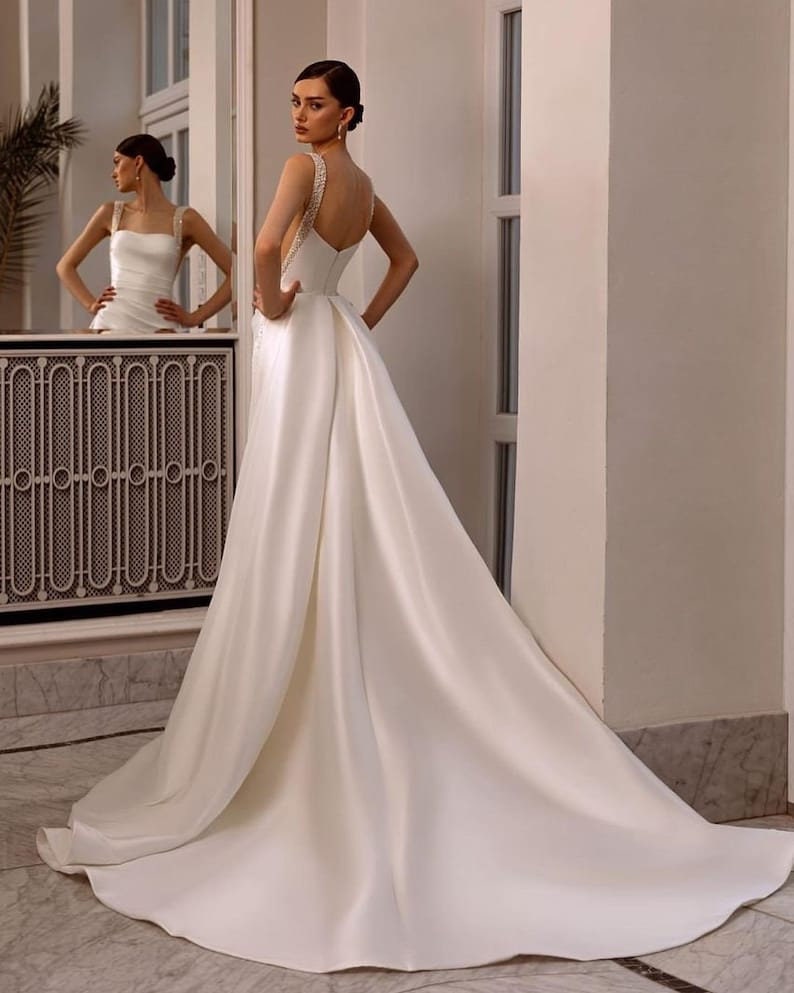 Sleeveless Multi Crystal Beaded Square Neck Satin Minimalist Gown With Detachable Sequin Appliqué Detail Train