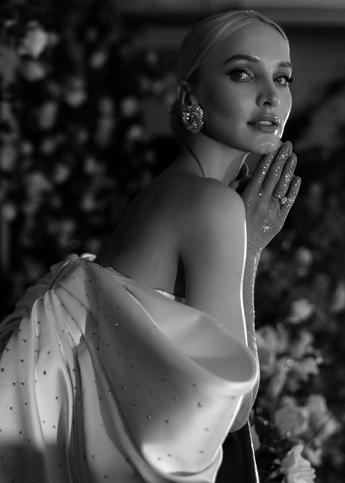 Boat Neck Strapless Scattered Crystal Embellished Satin Sheath Gown With Back Split Hem And Oversized Crystal Embellished Bow Knot Train