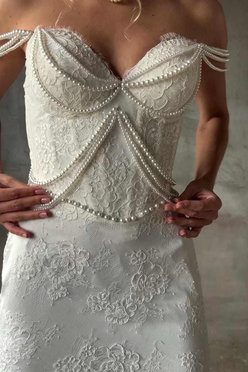 Pearl Beaded Spaghetti Strap Off The Shoulder Sweetheart Scattered Floral Lace Trumpet Bridal Gown With Draping Pearl Beading Detail