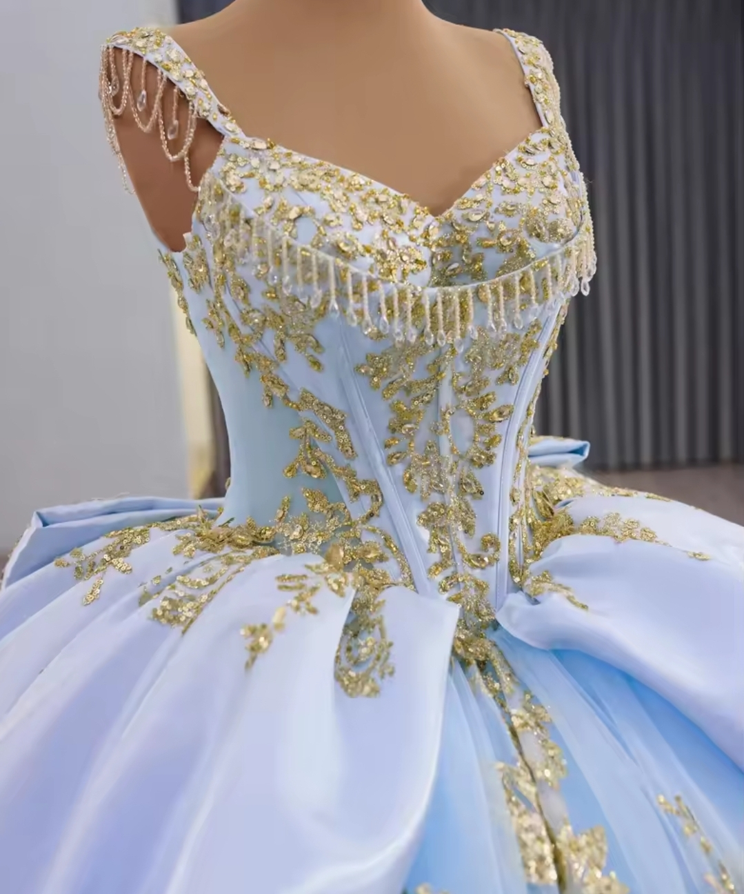 Multi Crystal Beaded Cap Sleeve Blue V Neck Corset A-Line Gone With 3D Floral Motiffs, Scattered Gold Appliqués And Oversized Back Bow Detail