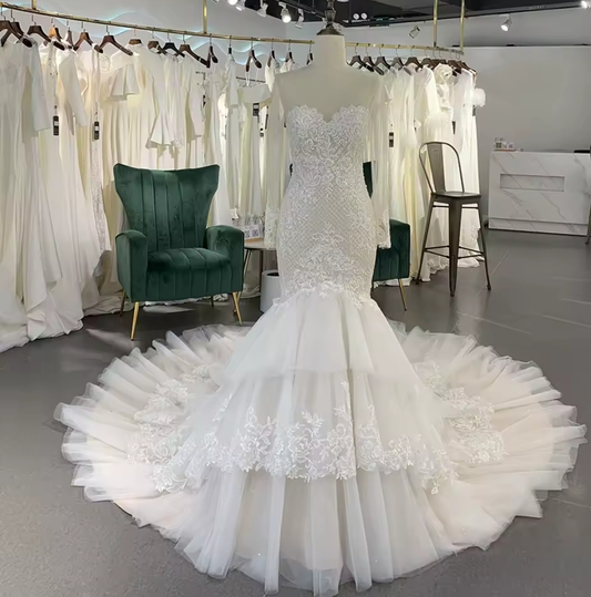 Long Sleeve Illusion Sleeve And Neckline Lace Sweetheart Fit To Flare Bridal Gown With Multi Layered Tiered Skirt Hem And Button Up Enclosure