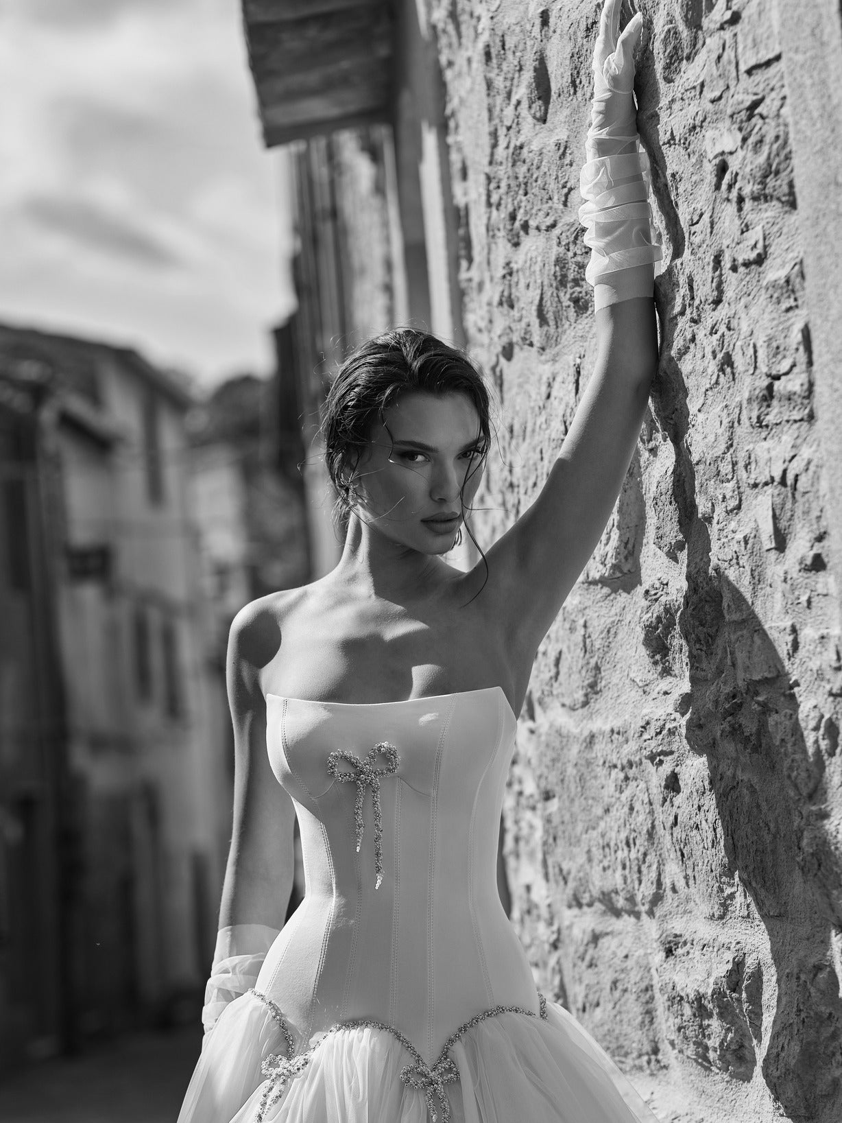 Cat Eye Scoop Strapless Corset With Center Beaded Bow Embellishment Bodice Wedding Gown With Multi Beaded Bow Scalloped Waist Detail And Detached Sheer Tulle Gloves