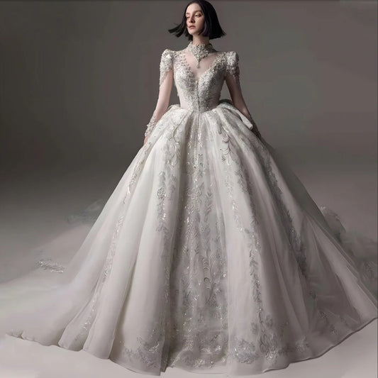 Angelic 2024 Multi Beaded Illusion Mid Neck Long Sleeve Tiered Ruffle Draped Waistline Princess Bridal Ball Gown