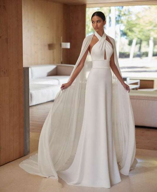 Simple Halter Neckline, Open Back 2 Piece Sheath Bridal Gown With Beaded Waist Detail And Flowing Cape