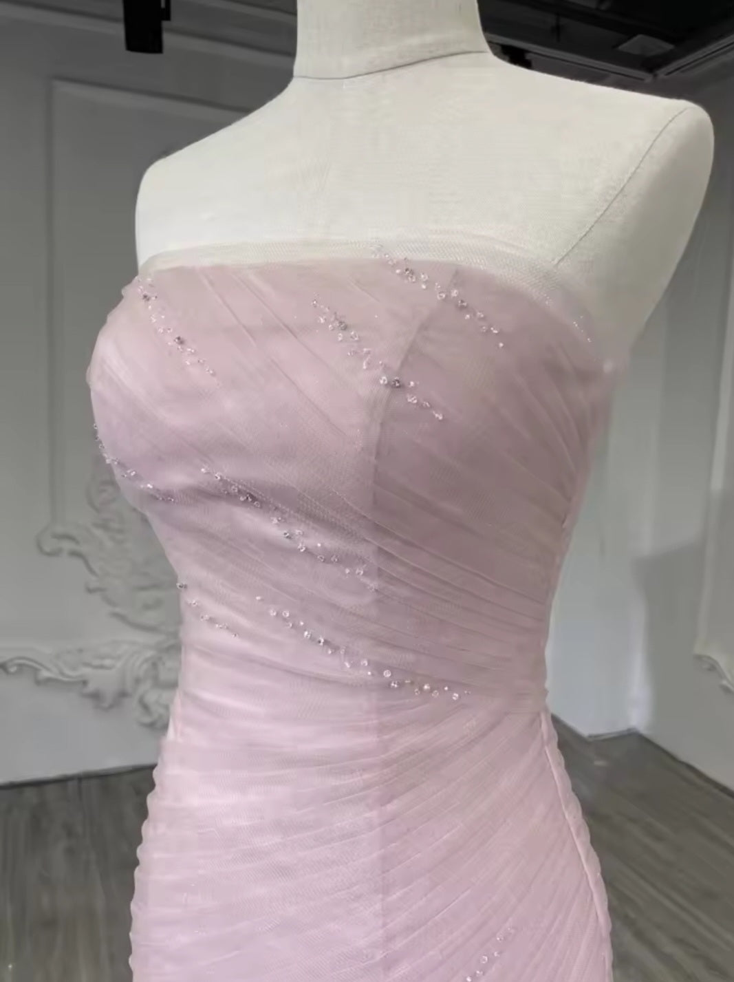 Strapless Boat Neck Scattered Beaded Detail With Pleated Criss Cross Design And Layered Skirt Fit To Flare Gown