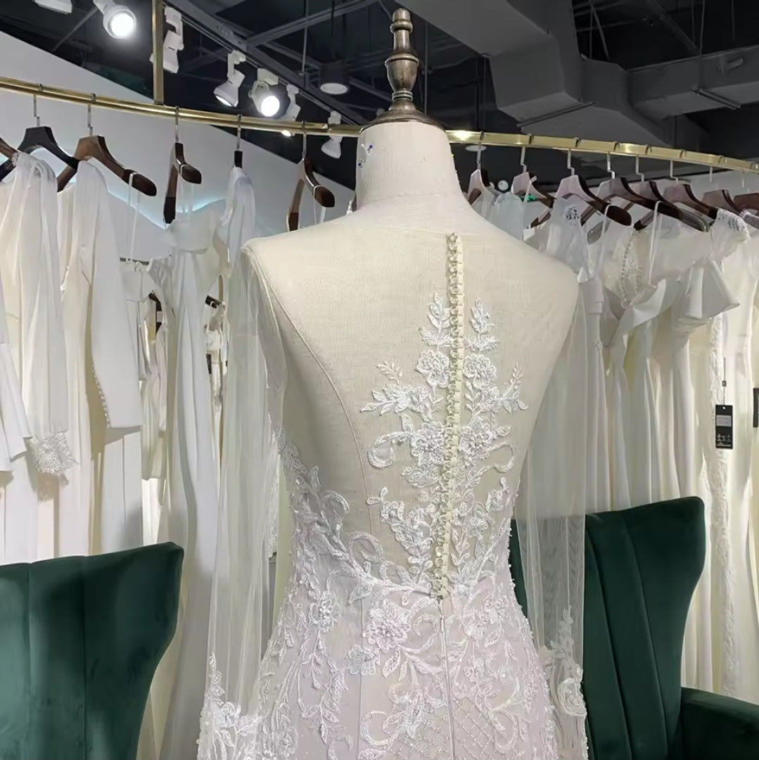 Long Sleeve Illusion Sleeve And Neckline Lace Sweetheart Fit To Flare Bridal Gown With Multi Layered Tiered Skirt Hem And Button Up Enclosure