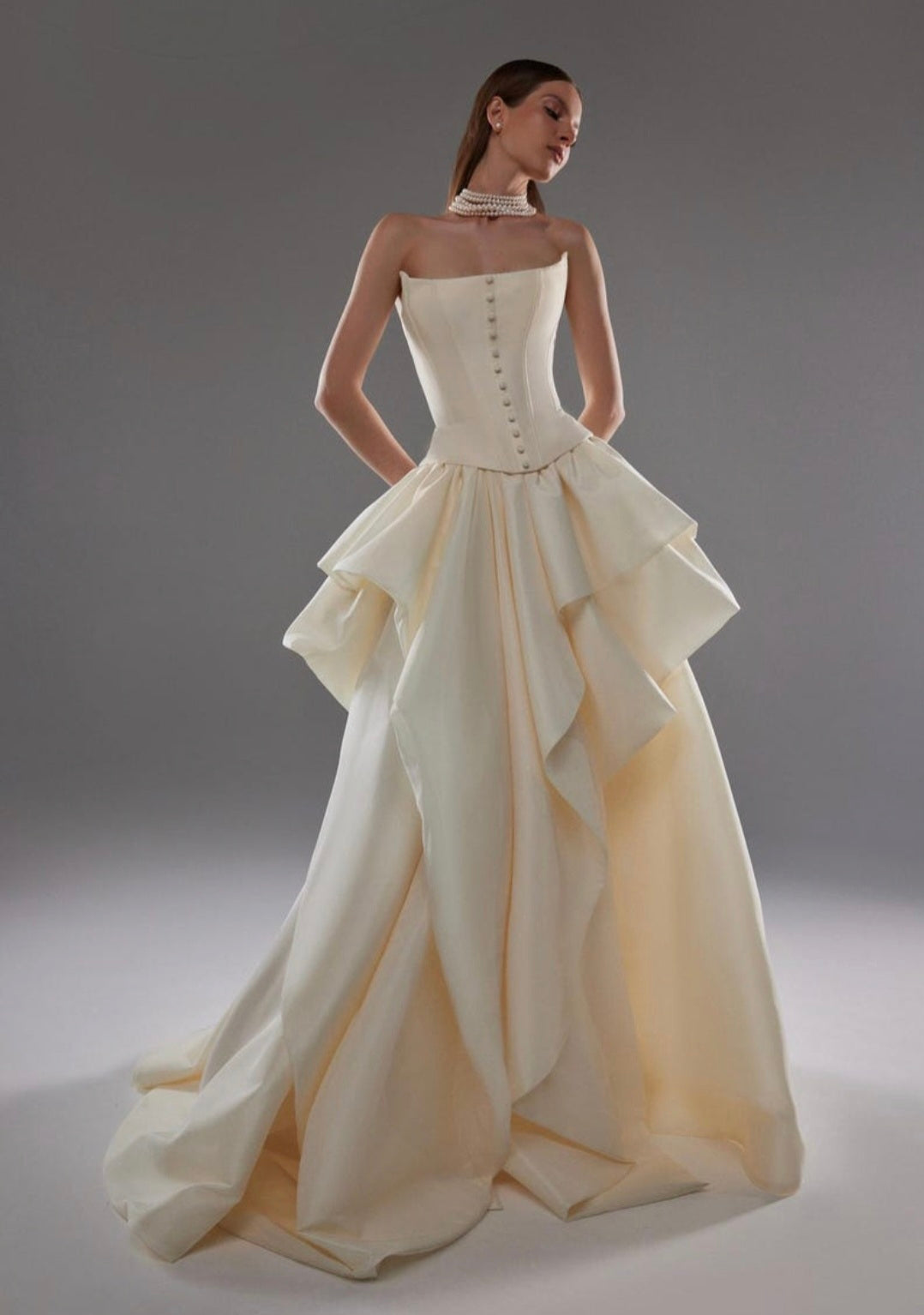 Cat Eye Boat Neck Strapless Front Multi Button Detail Corset Bridal And Ceremonial Gown With Multi Layered Skirt And Split Hem