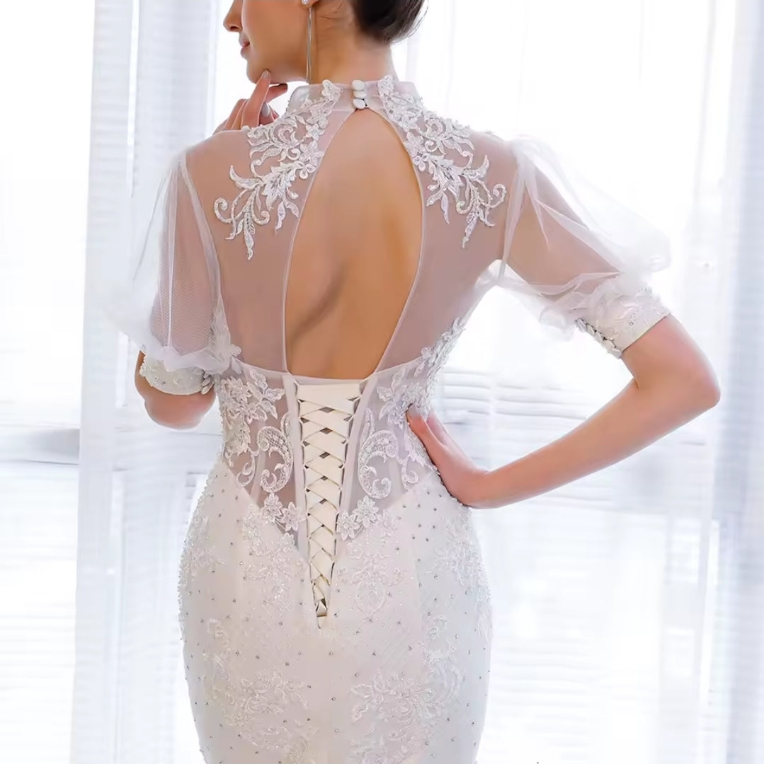 Ivory Sheer Half Sleeve Mid Neck Sheer Bodice With Lace Appliqué Detai Open Back Lace Up Fit To Flare Bridal Gown With 100 CM Train