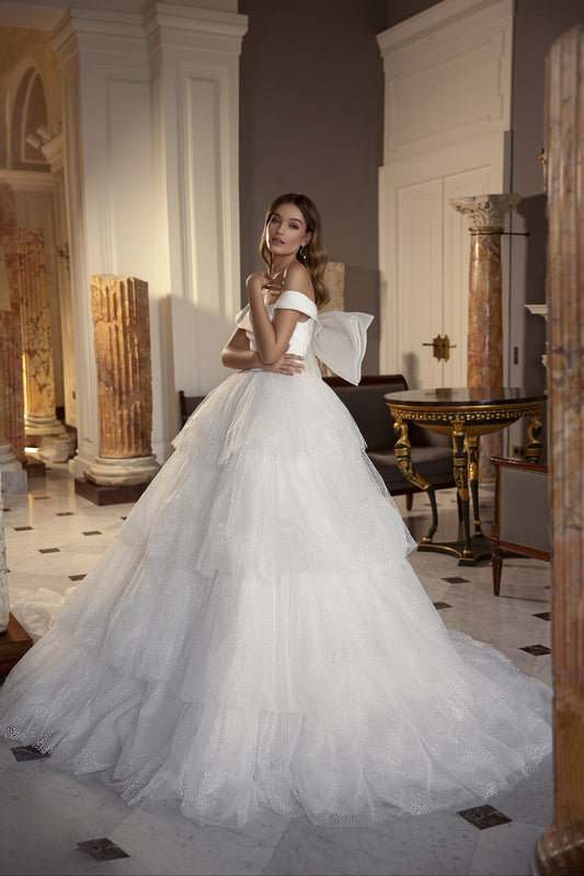 Sweetheart Pleated Off The Shoulder Satin Bodice & Glitter Tulle Gown With Exaggerated Bow Back