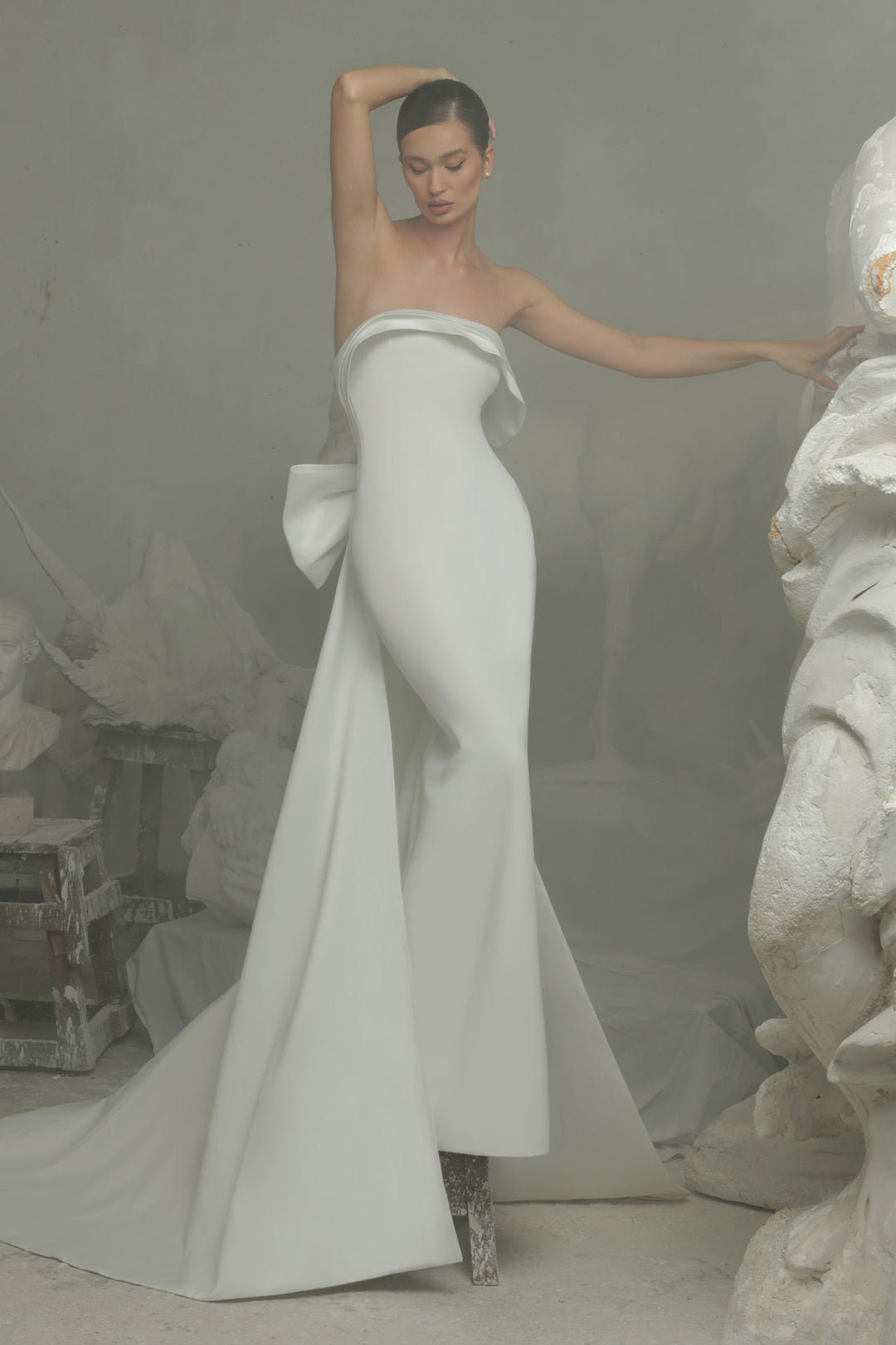 Simply Minimalist Layered Over Strapless Boat Neck Bodice Sheath Gown With Trailing Bow Knot Mermaid Train