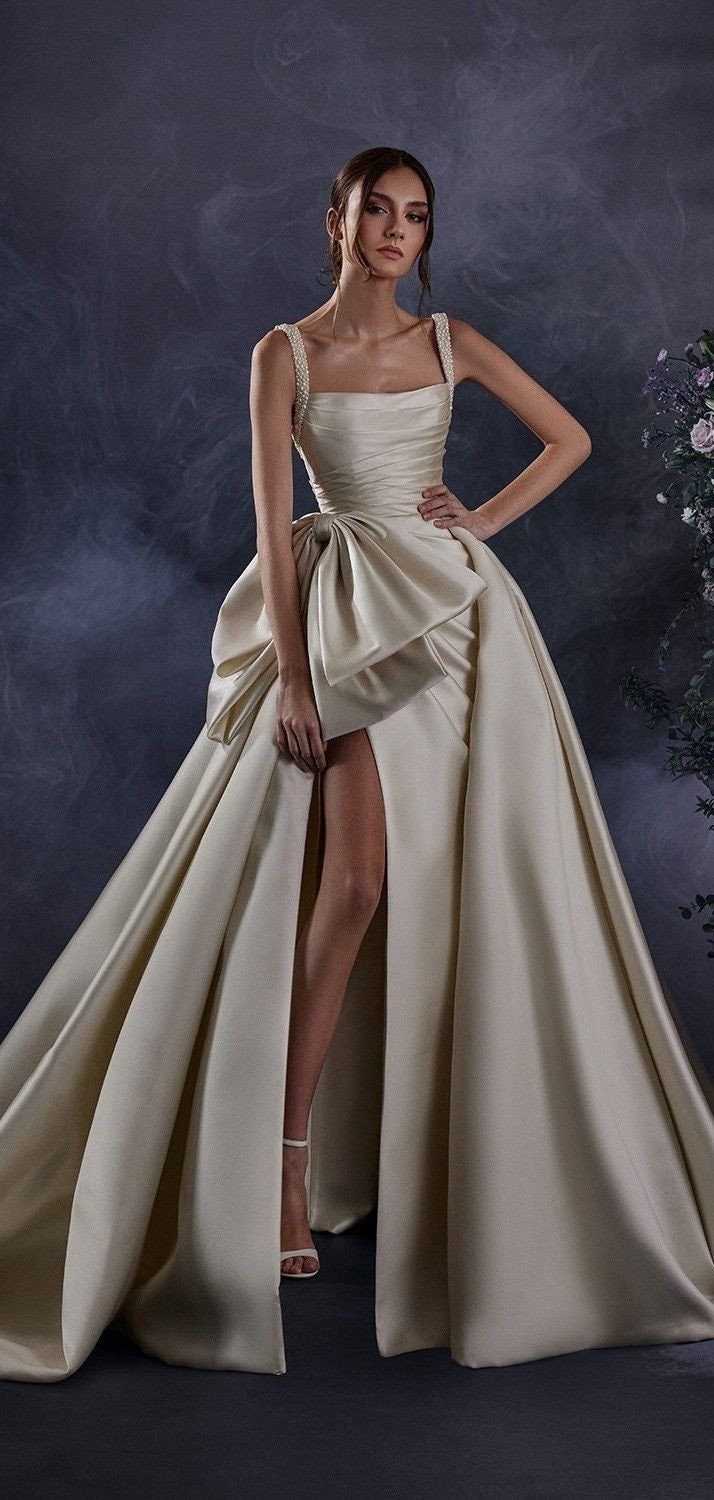 Pearl Beaded Spaghetti Strap Pleated Oversized Bow Knot Waistline Detail A-Line Gown With Thigh High Split Hem