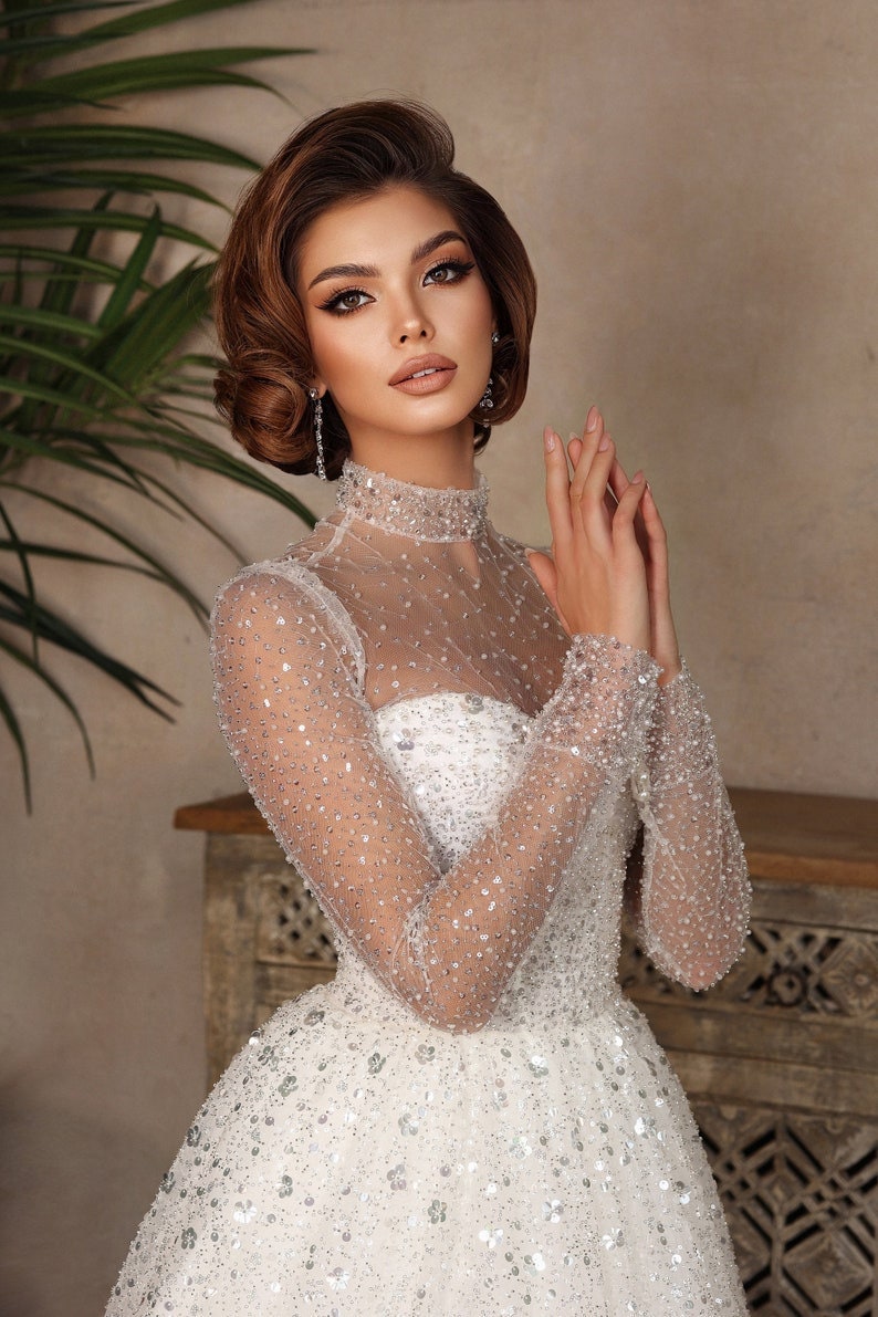 Whimsical Shimmering Sparkling Long Sleeve Mid Neck Sophisticated Sweetheart Bridal Gown