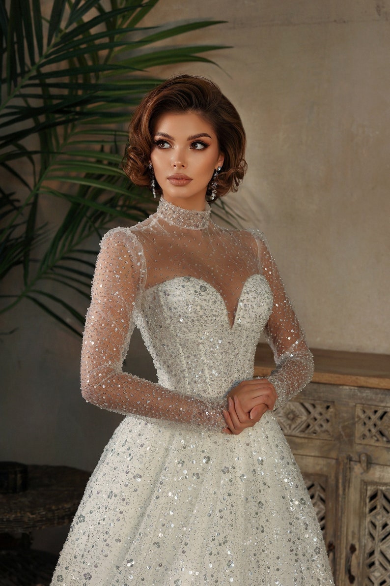 Whimsical Shimmering Sparkling Long Sleeve Mid Neck Sophisticated Sweetheart Bridal Gown