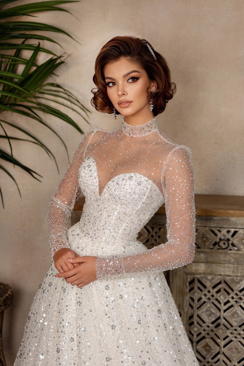 Whimsical Shimmering Sparkling Long Sleeve Mid Neck Sophisticated Sweetheart Bridal Gown