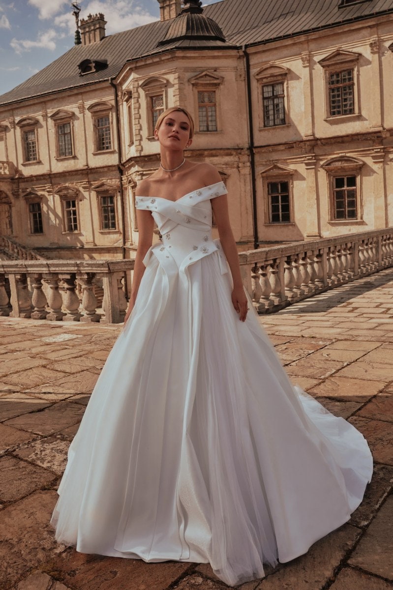 Embellished Off The Shoulder Pleated Criss Cross Bodice A-Line Gown With Detachable Modern Train