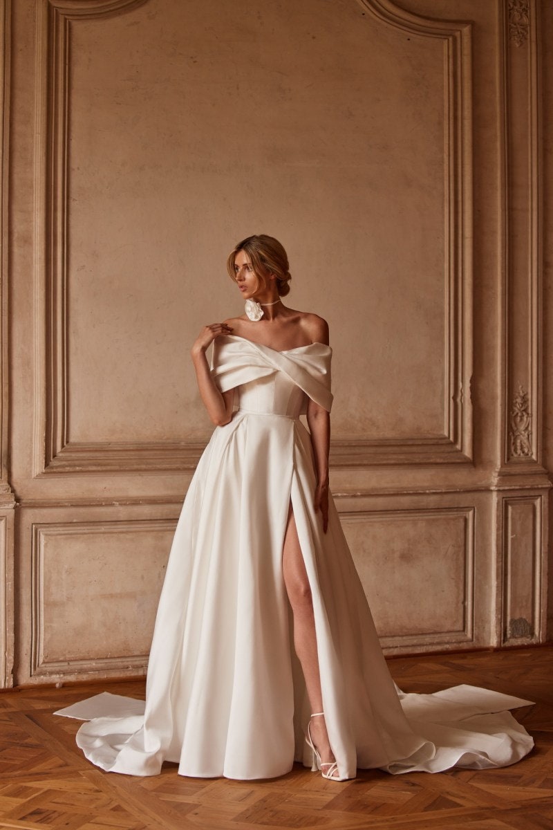 Criss Cross Off The Shoulder Pleated Corset Style A-Line Bridal Gown With Split Hem And 3D Floral Train Detail