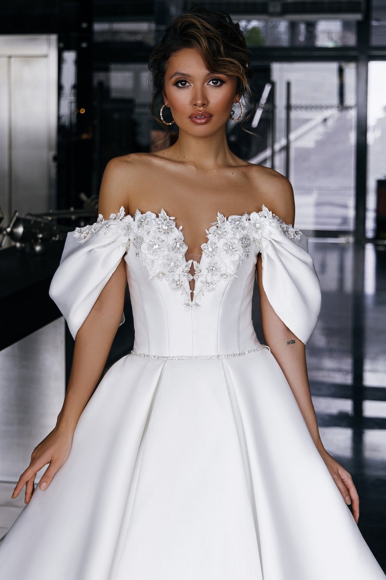 Pleated Off The Shoulder Sequin Floral Appliqué Plunging Sweetheart Neckline With Crystal Beaded Waistline A-Line Bridal Gown