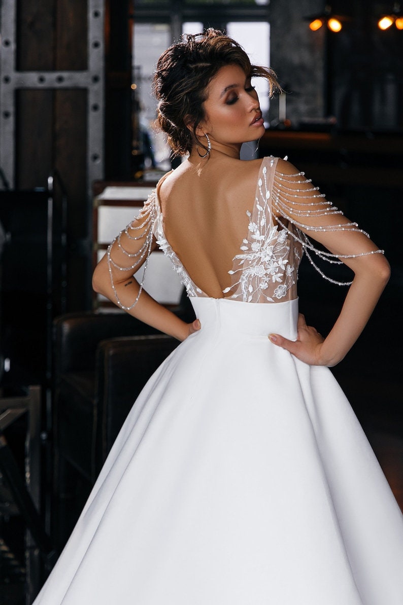 Sleeveless Draped Multi Beaded Detailed Floral Lace Appliqué Bodice With Natural Waistline Satin Bridal Gown With Open Back Zip Enclosure