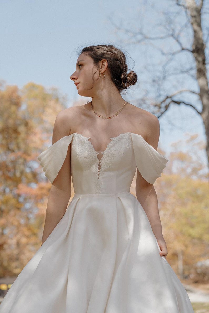 Pleated Off The Shoulder Plunging Sweetheart Floral Appliqué Minimalist A-Line Bridal Gown